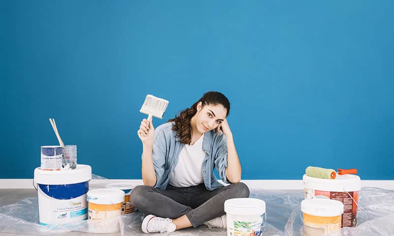 paint concept with sitting woman buckets
